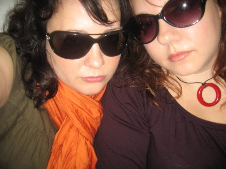 Alison Gary and Debbie Ashpes looking sad while wearing sunglasses in the Miami Airport