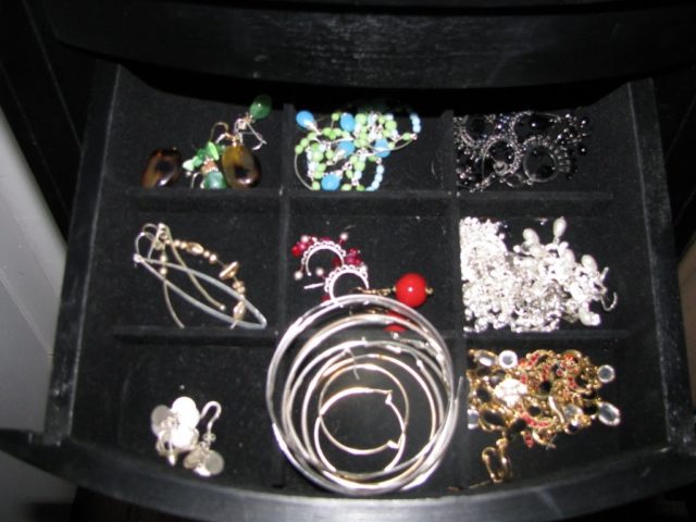 costume earrings in the drawer of a jewelry armoire