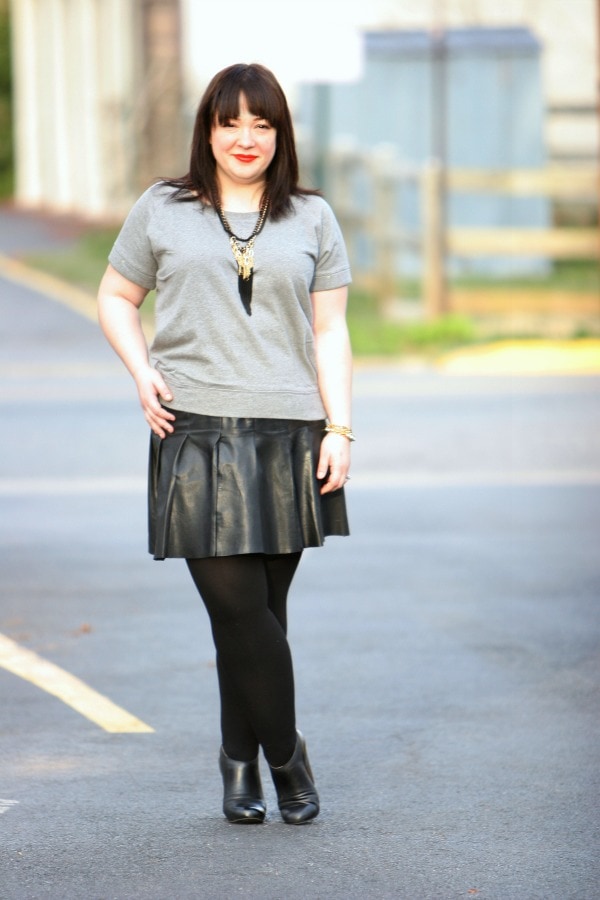What I Wore: Orange Pop 1 Alison Gary of Wardrobe Oxygen in a short sleeved Gap sweatshirt and a Halogen black leather drop waist pleated mini skirt