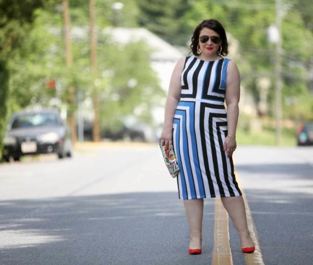 Wardrobe Oxygen in a Vince Camuto black, white, and blue graphic dress, Novica clutch, and orange Nine West pumps