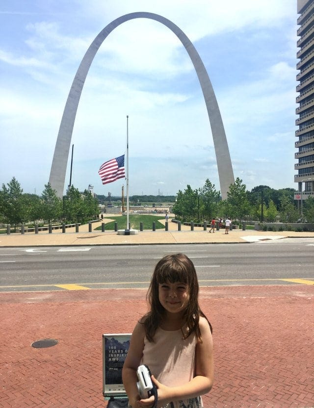 Emerson on the Courthouse stairs with the Gateway Arch in the Background