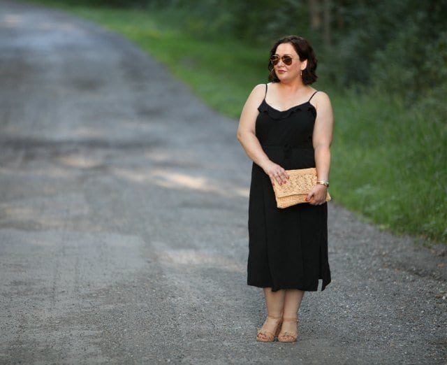 Wardrobe Oxygen Over 40 blogger in black sundress from ASOS with straw clutch