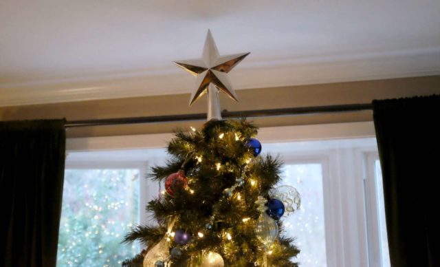 Me, Myself, and Pottery Barn 1 The top of a Christmas tree topped with a silver star from Pottery Barn