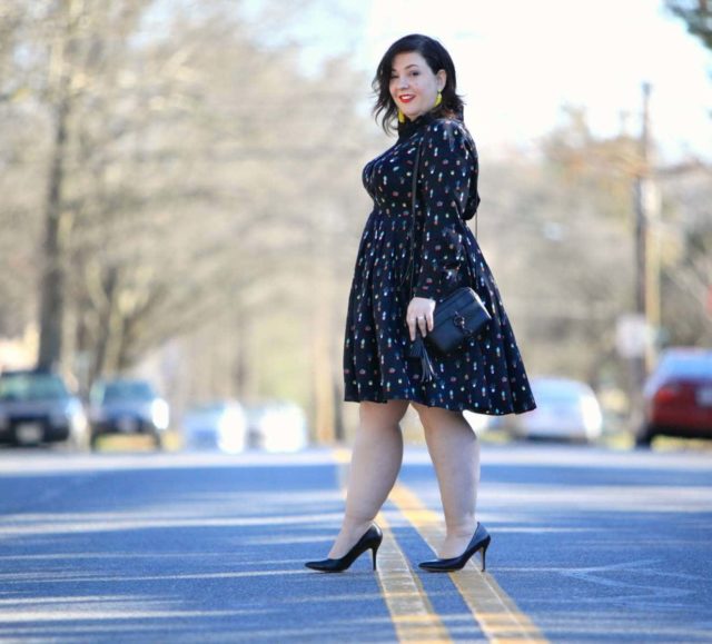 Wardrobe Oxygen in an Eloquii Conversational Dress, Rebecca Minkoff bag, and Baublebar tassel earrings