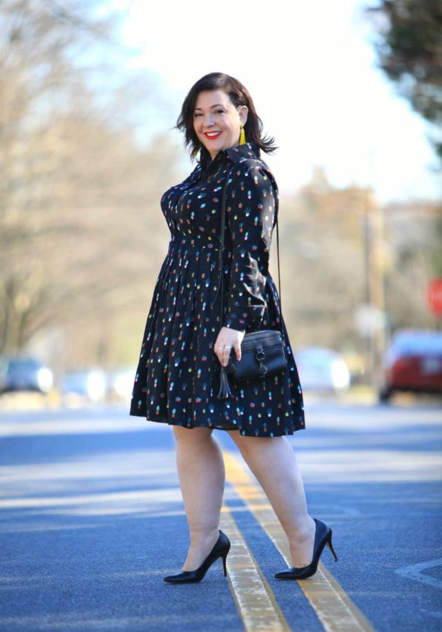 Wardrobe Oxygen in an Eloquii Conversational Dress, Rebecca Minkoff bag, and Baublebar tassel earrings