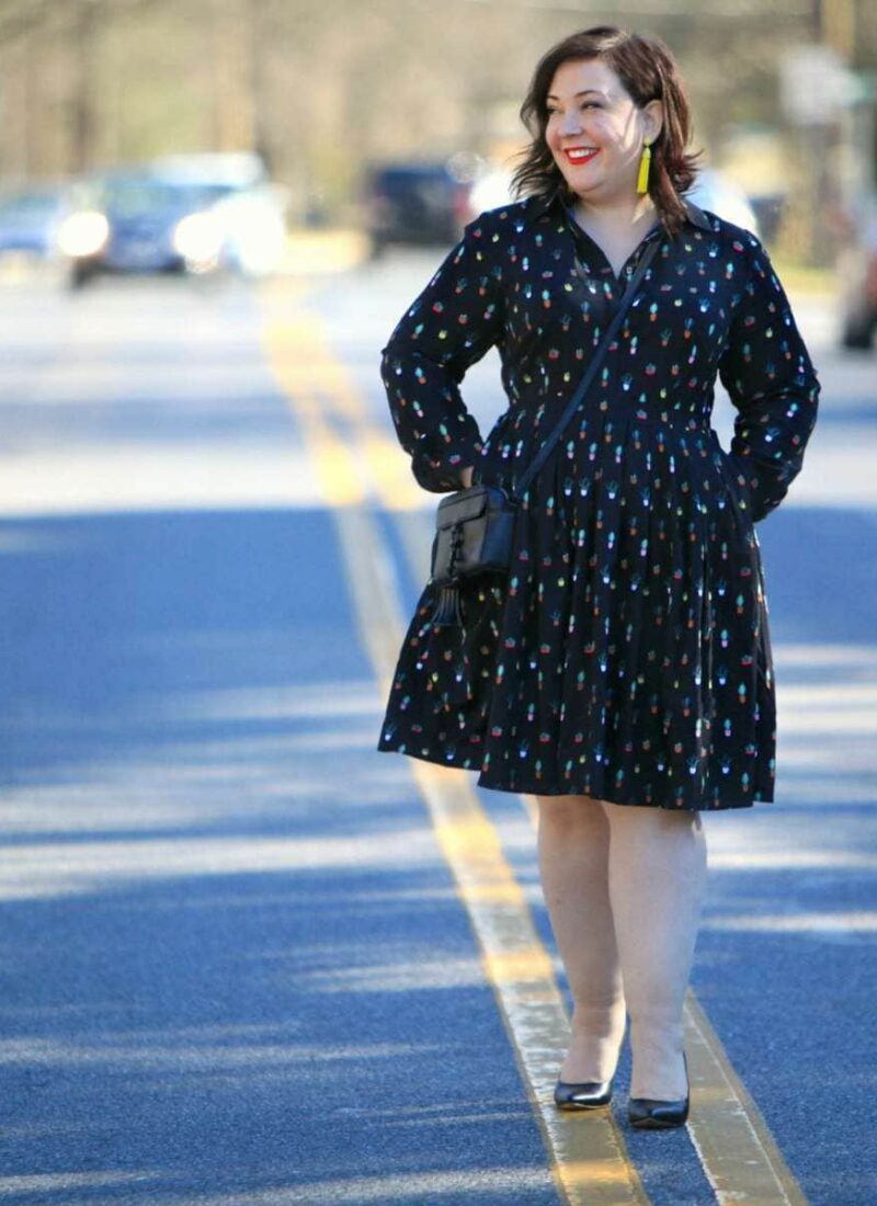 Wardrobe Oxygen in an Eloquii Conversational Dress, Rebecca Minkoff bag, and Baublebar tassel earrings