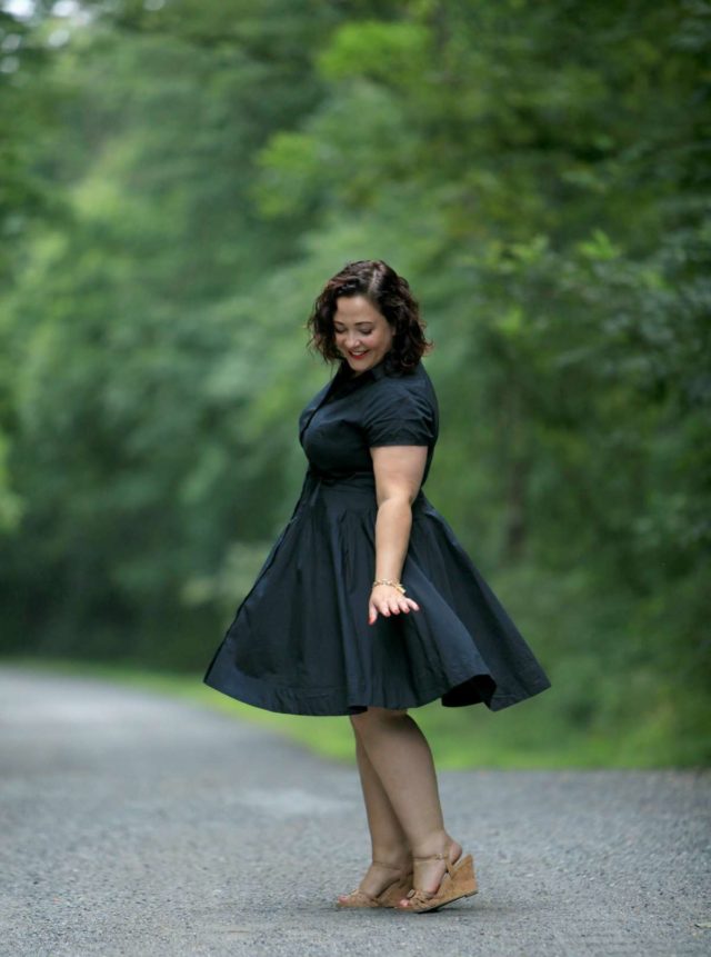 Wardrobe Oxygen in a black cotton shirt dress from ellos with Aerosoles wedge sandals and a raffia clutch bag