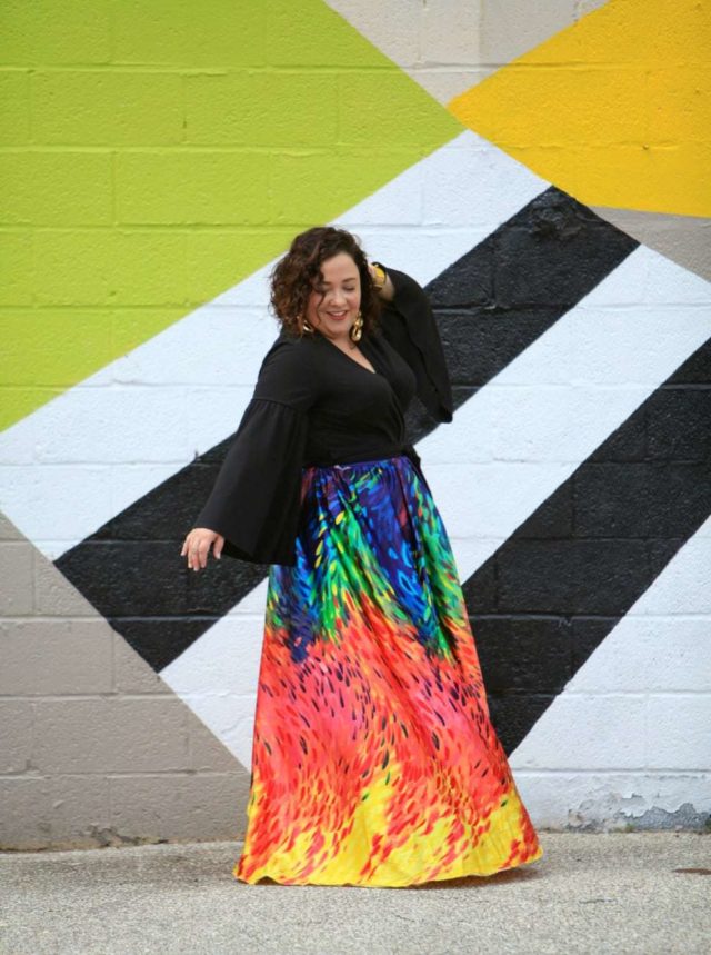 Wardrobe Oxygen in an ELOQUII wrap top, custom made rainbow maxi skirt from Trinity Michelle, and vintage gold earrings