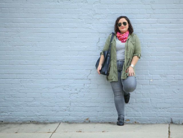 wardrobe oxygen in grey jeans and an olive utility jacket