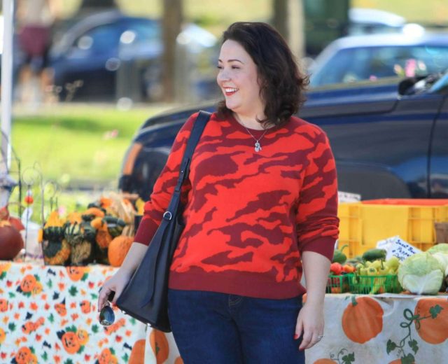 Wardrobe Oxygen in a red camo print sweater from cabi with an ALLSAINTS black leather tote