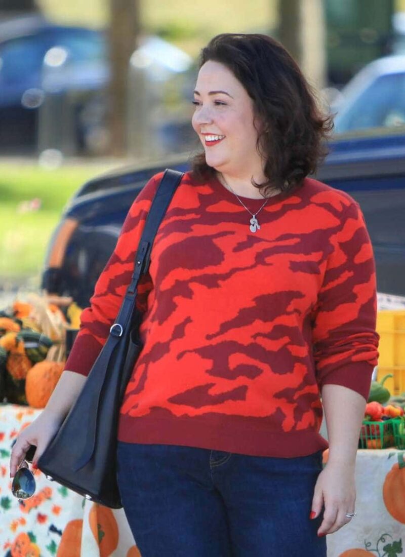 Wardrobe Oxygen in a red camo print sweater from cabi with an ALLSAINTS black leather tote