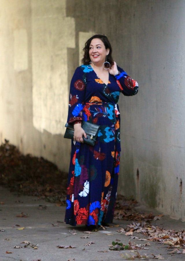 Wardrobe Oxygen in an ELOQUII dark floral maxi dress with an Ellos black faux fur coat and Clare V green crocs clutch