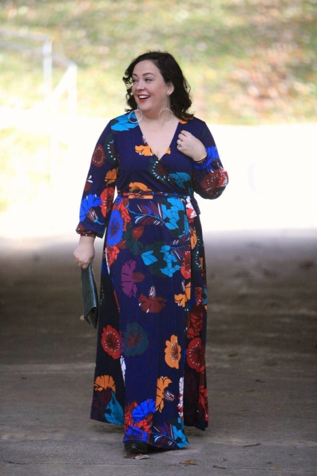 Wardrobe Oxygen in an ELOQUII dark floral maxi dress with an Ellos black faux fur coat and Clare V green crocs clutch