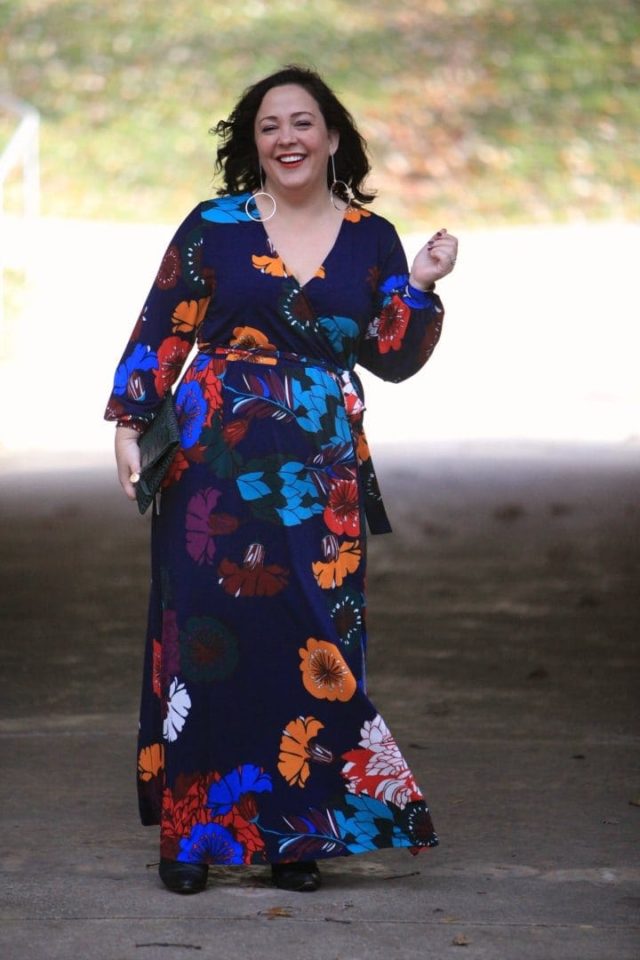 Wardrobe Oxygen in an ELOQUII dark floral maxi dress with an Ellos black faux fur coat and Clare V green crocs clutch