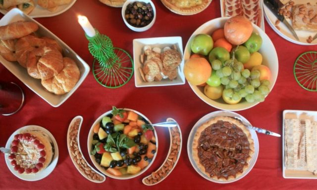 display of brunch food on a red tablecloth