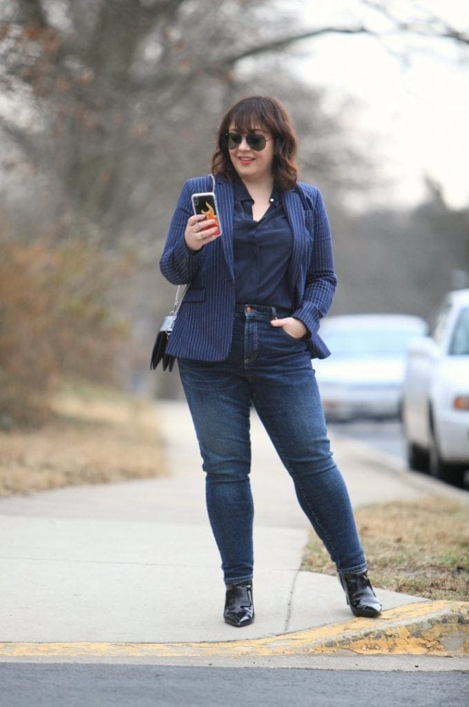 Alison wearing Universal Standard Siene jeans with a navy blazer and navy silk blouse