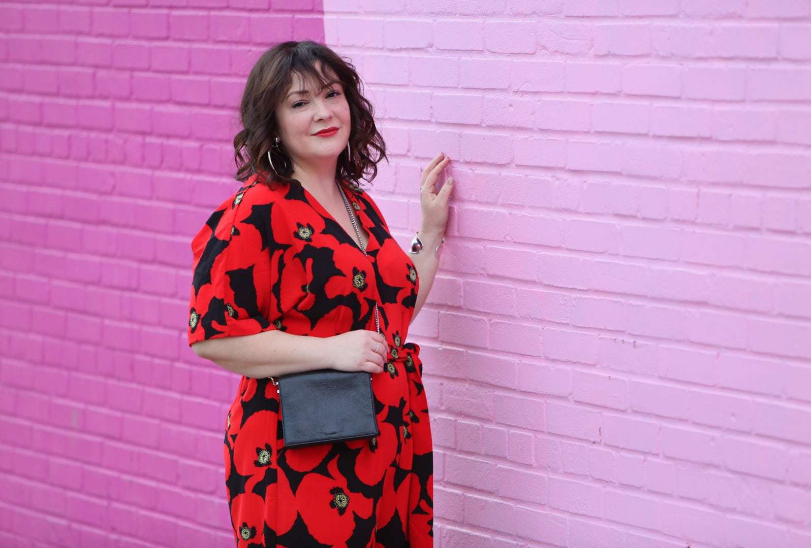 Wardrobe Oxygen in a red floral jumpsuit from ELOQUII with Rothy's flats