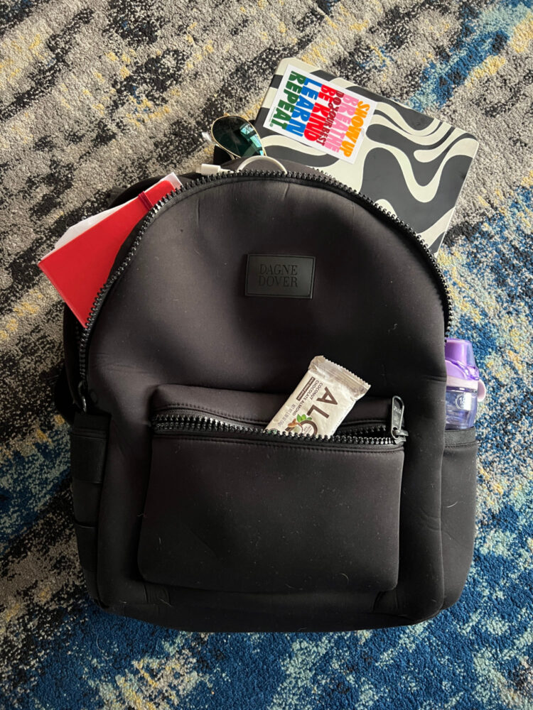 I’ve Owned the Dagne Dover Dakota Backpack for Over 5 Years: Here’s My Honest Review 3 The large Dagne Dover Dakota backpack holding a Macbook, protein bar, moleskine book, and more