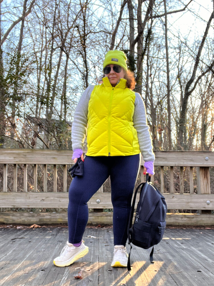 I’ve Owned the Dagne Dover Dakota Backpack for Over 5 Years: Here’s My Honest Review 5 Woman in winter athletic gear carrying a large Dagne Dover Dakota backpack full of heavy weights for rucking