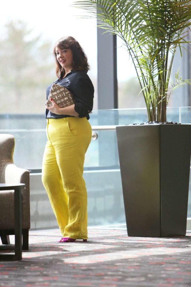 Wardrobe Oxygen in yellow linen pants from Talbots with a navy silk blouse and silver Monserat De Lucca woven clutch