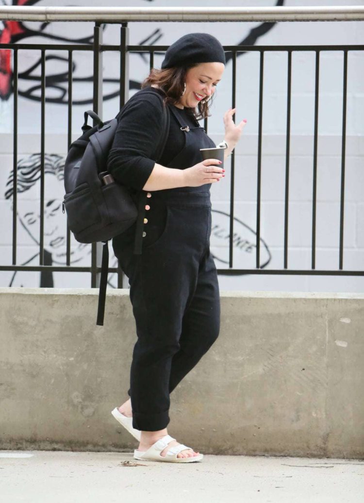 Universal Standard black overalls with a black cashmere sweater, EVA Birkenstocks, and the Dagne Dover Dakota backpack on Wardrobe Oxygen