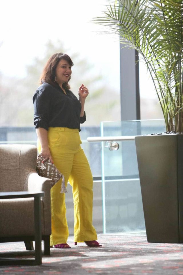 Wardrobe Oxygen in yellow linen pants from Talbots with a navy silk blouse and silver Monserat De Lucca woven clutch