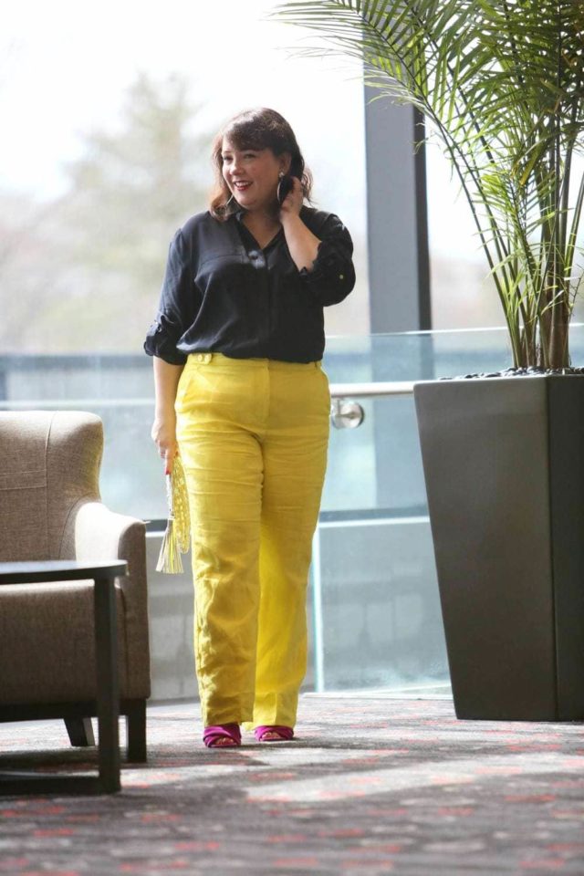 Wardrobe Oxygen in yellow linen pants from Talbots with a navy silk blouse and silver Monserat De Lucca woven clutch