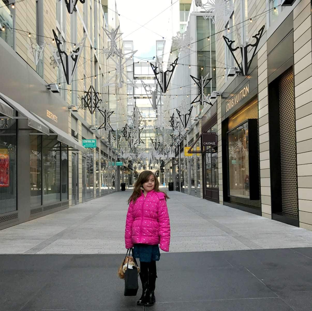 photo of my daughter in CityCenter DC carrying what I hoped to be a replacement for my first designer bag, the Kate Spade Sam.