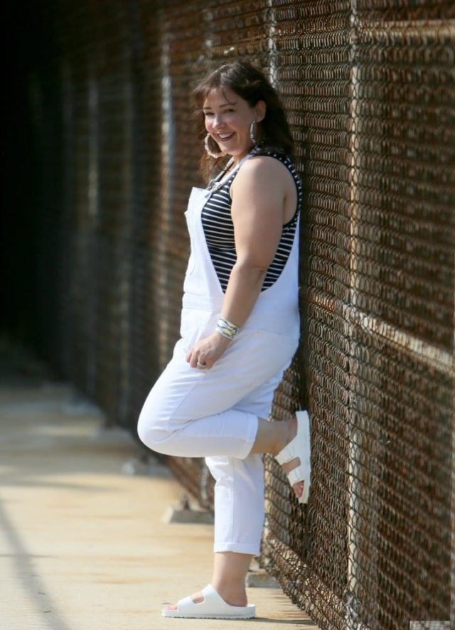gap white overalls with white birkenstocks and a black and white striped tank top