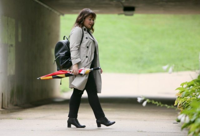 Alison Gary of Wardrobe Oxygen in a Universal Standard Trench Coat with Maryland Flag golf umbrella, navy Talbots cashmere sweater and black Chico's ponte pants