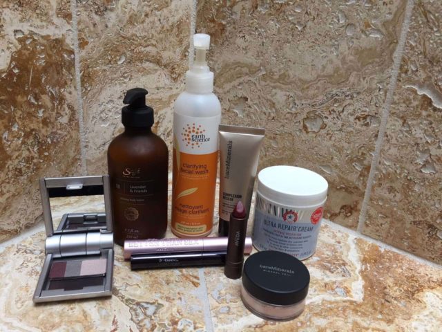 The beauty routine of Stella Carakasi. Photo depicts several bottles and jars of natural beauty skincare products on a counter.