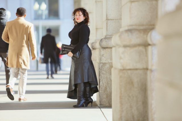 Wardrobe Oxygen in a black cashmere turtleneck, black leather asymmetrical skirt from Topshop, and silver Jenny Bird Trust Hoops with black knee-high wide calf heeled boots #over40fashion #40plusstyle #petitefashionblogger