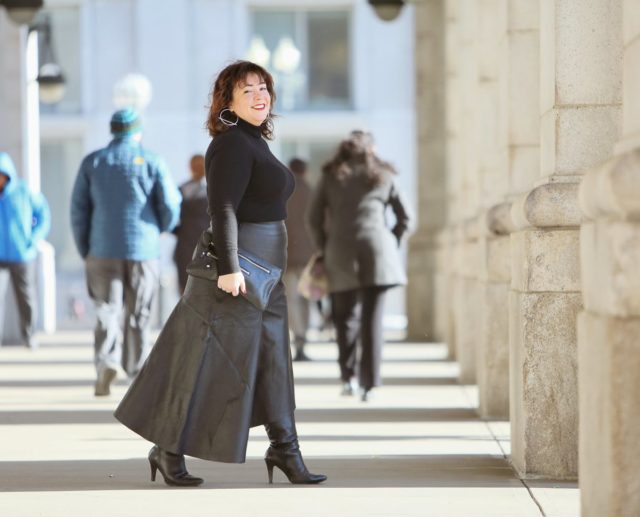 Wardrobe Oxygen in a black cashmere turtleneck, black leather asymmetrical skirt from Topshop, and silver Jenny Bird Trust Hoops with black knee-high wide calf heeled boots #over40fashion #40plusstyle #petitefashionblogger