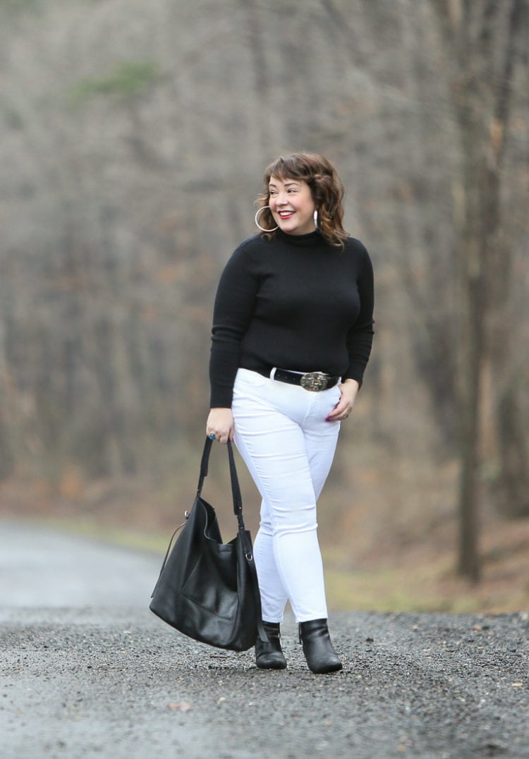 Black Coolmax turtleneck and white stain resistant jeans from Chico's styled on Wardrobe Oxygen with black Clarks ankle boots and the ALLSAINTS North/South tote