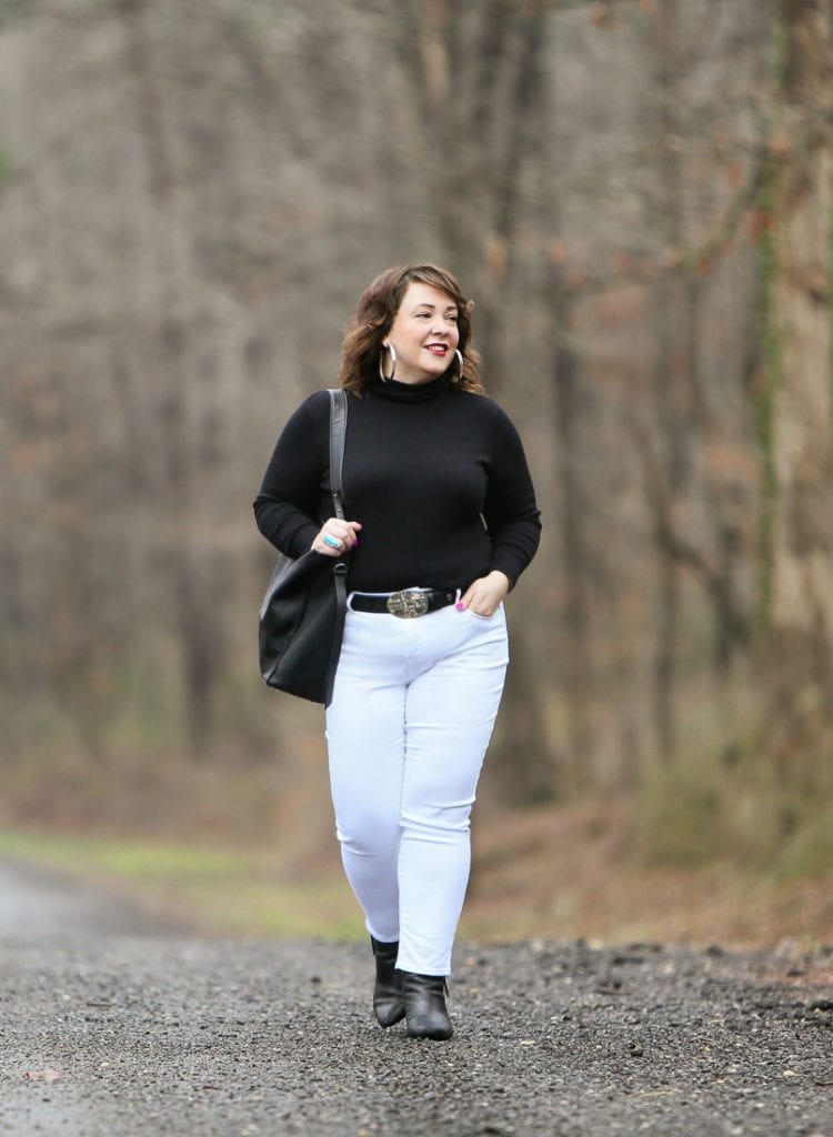 Black Coolmax turtleneck and white stain resistant jeans from Chico's styled on Wardrobe Oxygen with black Clarks ankle boots and the ALLSAINTS North/South tote