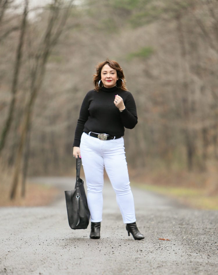 Black Coolmax turtleneck and white stain resistant jeans from Chico's styled on Wardrobe Oxygen with black Clarks ankle boots and the ALLSAINTS North/South tote