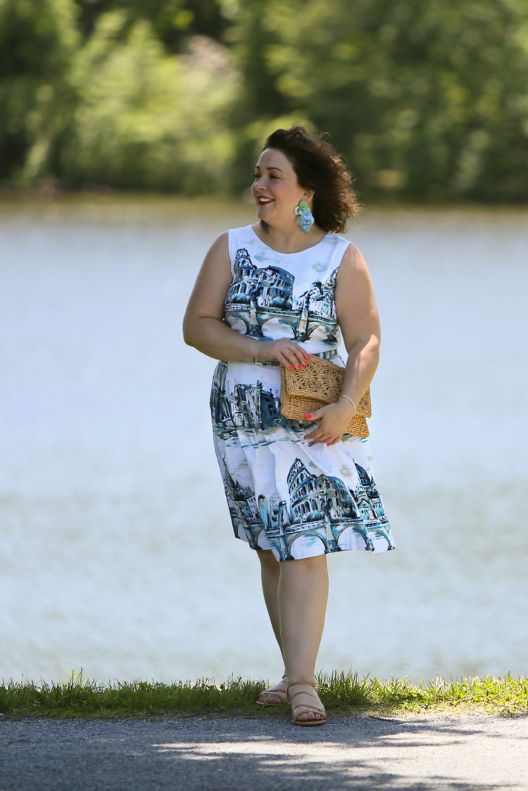 Rome-inspired printed fit and flare dress from Talbots styled with a woven straw clutch purse, Zara earrings, and Talbots wide width wedge sandals