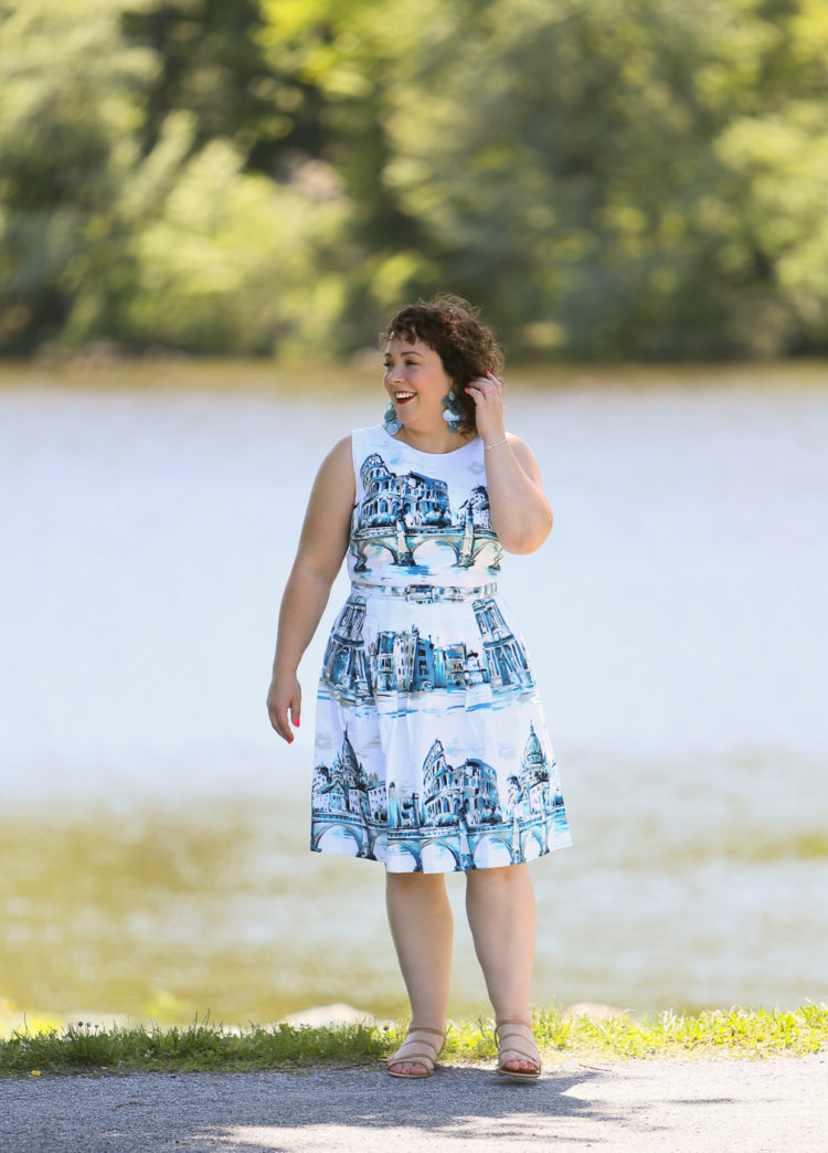 Rome-inspired printed fit and flare dress from Talbots styled with a woven straw clutch purse, Zara earrings, and Talbots wide width wedge sandals