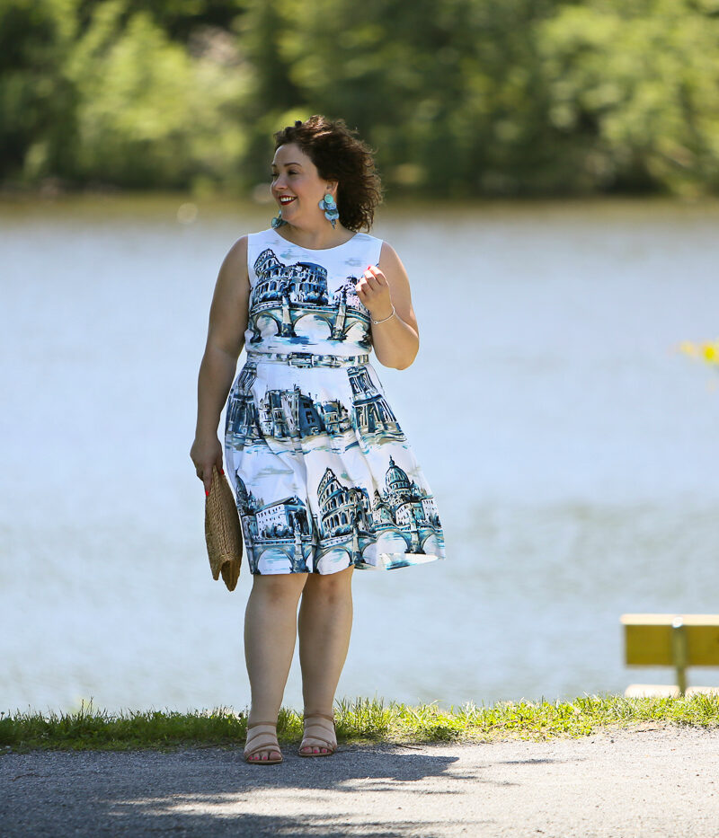 Rome-inspired printed fit and flare dress from Talbots styled with a woven straw clutch purse, Zara earrings, and Talbots wide width wedge sandals