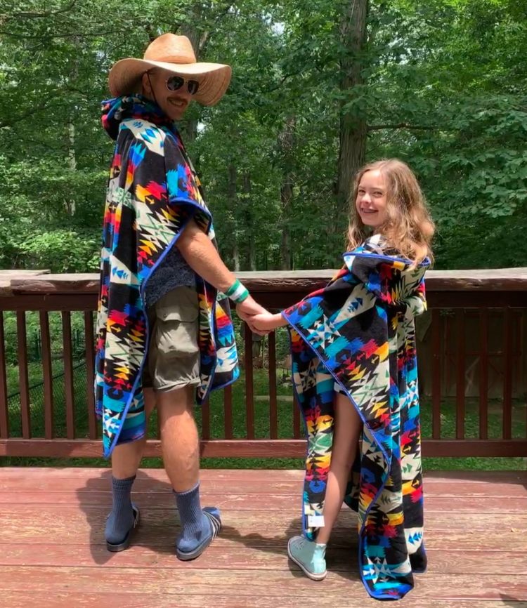 alison's husband and daughter standing on their patio wearing matching hooded Pendleton towels