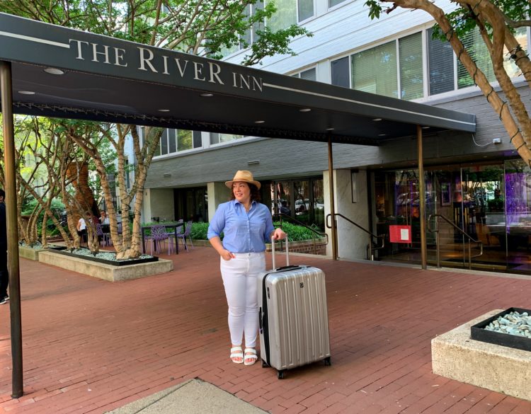 image of Wardrobe Oxygen standing under and awning that reads The River Inn