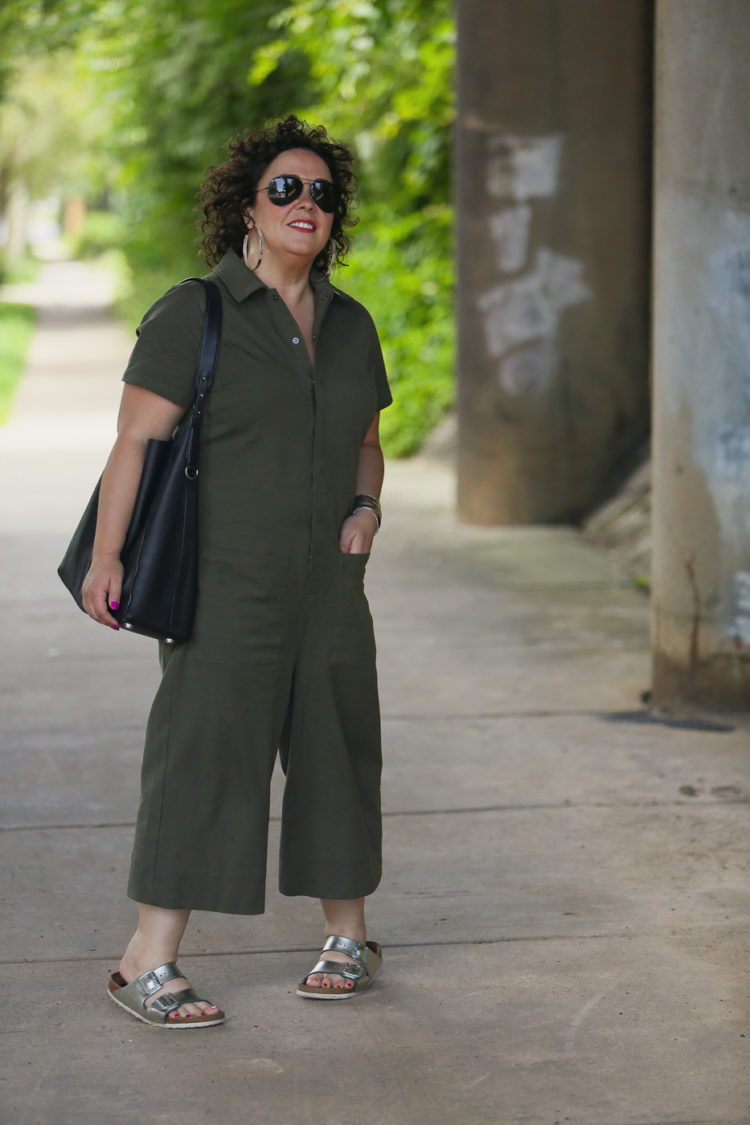 Wardrobe Oxygen in the Universal Standard Kate Twill Jumpsuit in green with silver Birkenstocks and the Jenny Bird Cober Hoops in Silver