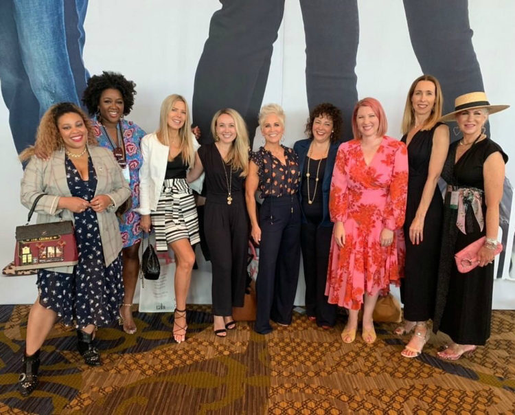 a group of women wearing cabi smiling for the camera