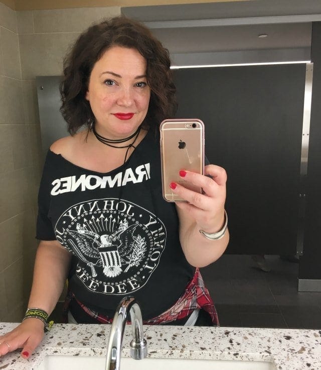 Alison Gary in a Ramones off the shoulder t-shirt taking a mirror selfie