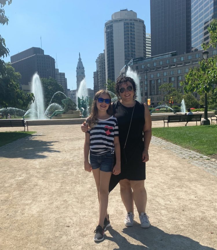 mother and daughter standing in front of fountain at logan circle in philadelphia
