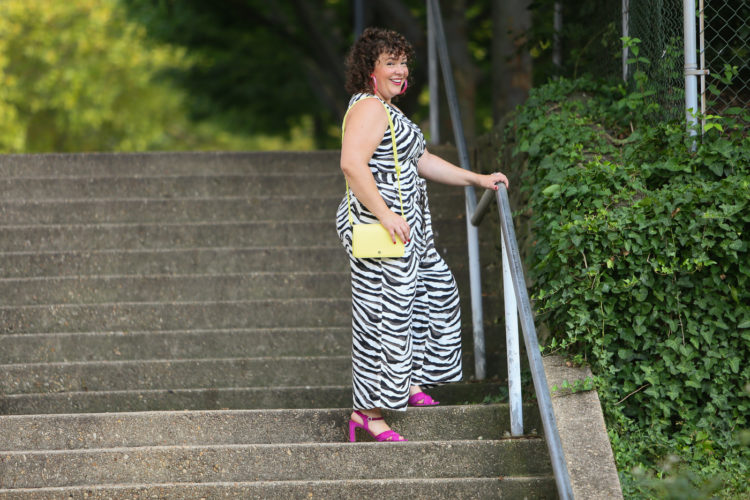Wardrobe Oxygen in a zebra jumpsuit from Banana Republic with a highlighter yellow Dagne Dover bag and hot pink heels and BaubleBar lucite hoops