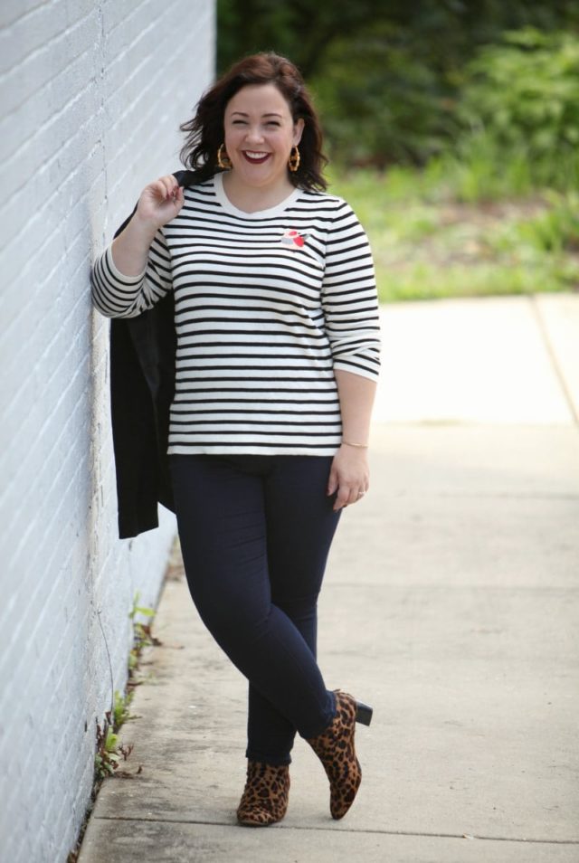 Alison in a black and white striped sweater with dark wash JAG jeans and leopard print ankle booties