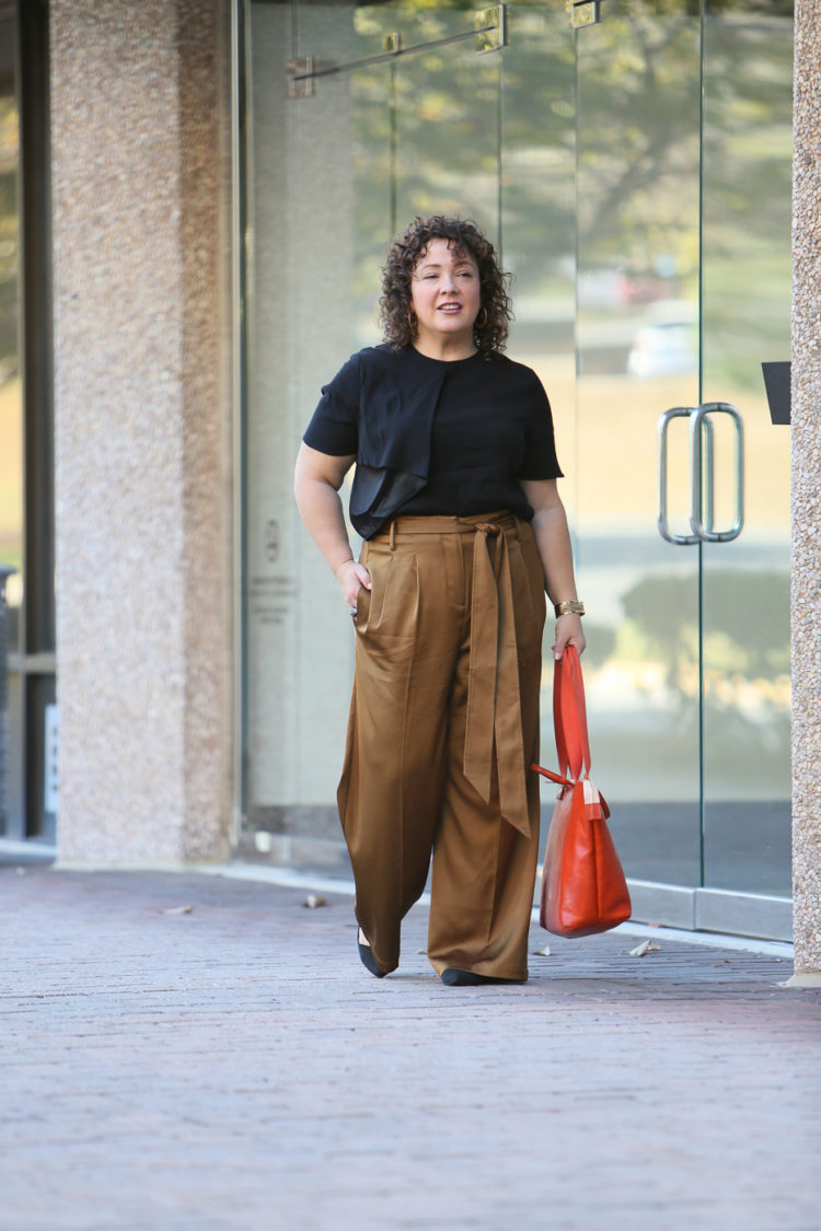 Wardrobe Oxygen in Universal Standard Abagail Top and Tresa Wide Leg Pants with a Clare V. Le Zip Sac Tote in orange