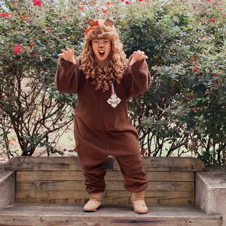 woman in a costume to be the cowardly lion from the wizard of oz