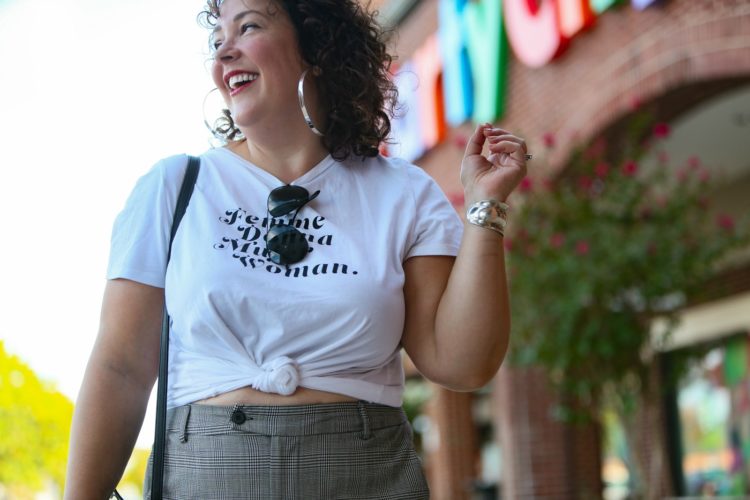 woman in white graphic t-shirt and plaid wide leg pants